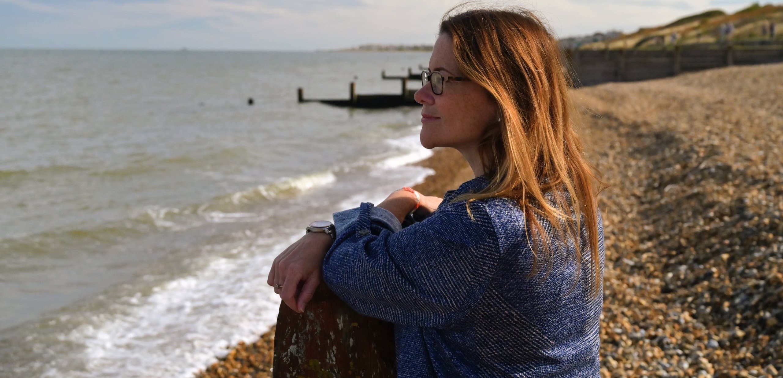 Joanna Roberts looking out to sea from the beach